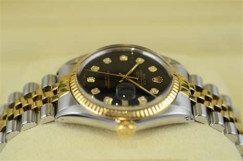 goldene rolex mit schwarzem zifferblatt